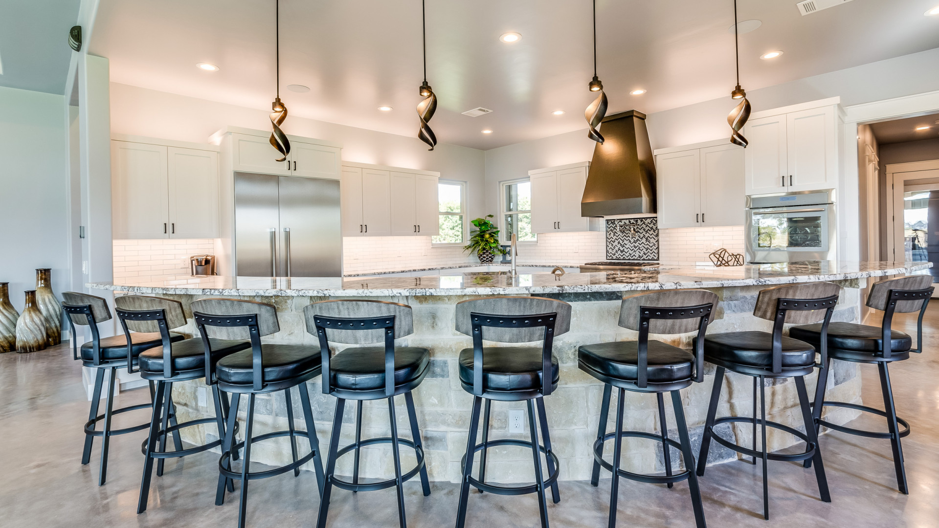 Light and bright eat-in kitchen boasting an oversized wraparound island, Home Builder Horseshoe Bay TX