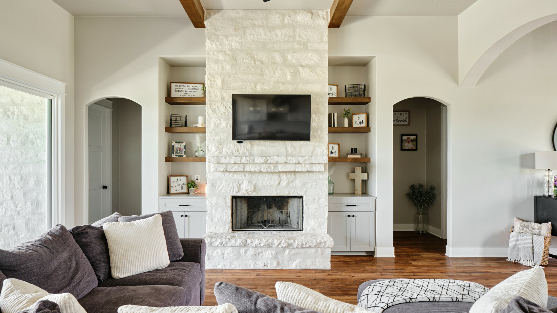 Cozy living room featuring a white brick fireplace and exposed wood beams, Lake LBJ TX
