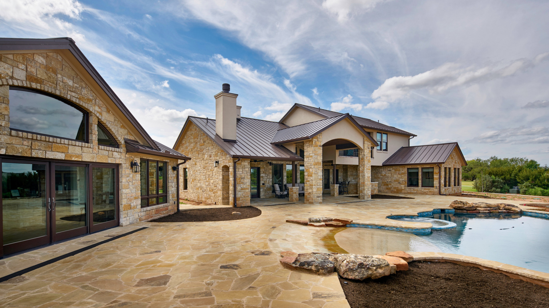 Lakeside stone luxury home boasting a zero entry pool and private dock, Lake LBJ TX
