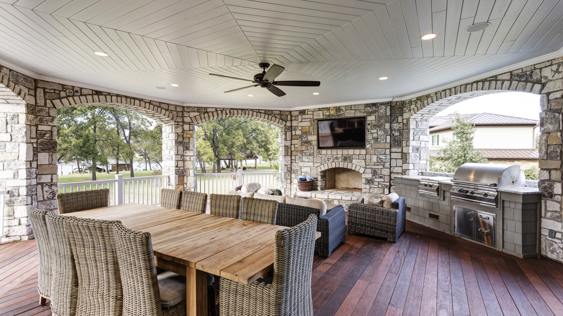 Custom outdoor oasis featuring a fireplace and built-in grill area, Lake LBJ TX