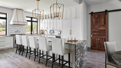 Elegant kitchen boasting an oversized marble island and custom made sliding barn doors, Lake LBJ TX