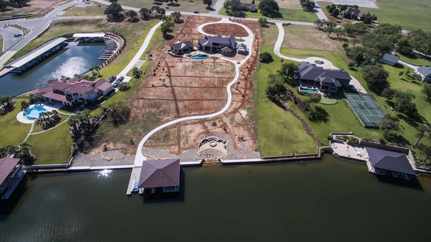 Aerial view of rustic lakeside home with a private dock, Lake LBJ TX